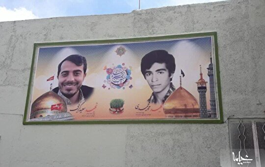کار خوب جوانان محله مسجد امام حسن مجتبی(ع) در تزیین دیوارنگاره با عکس شهدا